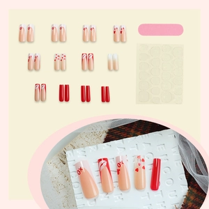 Long coffin red heart press-on nails set with XO designs and manicure accessories
