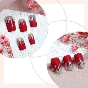 Long matte red press-on nails with silver glitter flame design and square tips