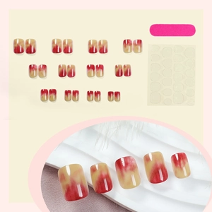 Short square press-on nails with red-yellow gradient design and complete tool kit