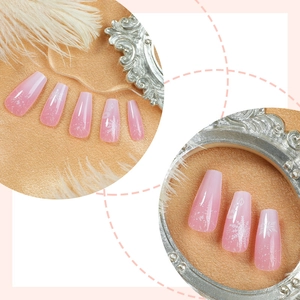 Pink gradient coffin nails with delicate white snowflake patterns and glossy finish