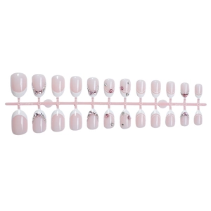 Pink and white French press-on nails with sparkling rhinestones and crystal accents
