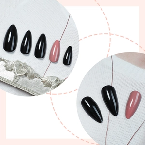 Glossy black and dusky pink almond shape press-on nails set on white textured background