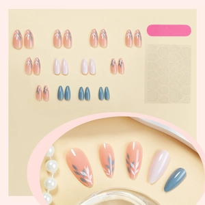 Almond press-on nails set in nude pink, white, and blue with leaf patterns and glue