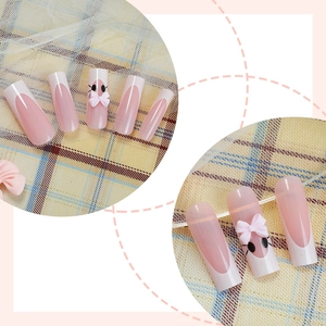 Detail of pink long French press-on nails with 3D bow and kitten art designs