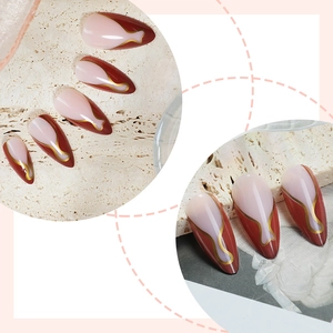 Brown French almond press-on nails with golden wavy lines and deep red accents