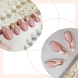Almond press-on nails with white French gold swirls and soft pink gradient finish