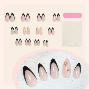 Faux ongles amande noirs style français avec étoiles dorées et strass brillants