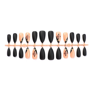 Winter snowflake press-on nails in matte black and nude pink with gold geometric lines