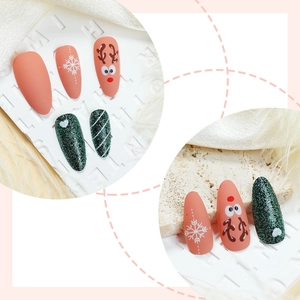 Christmas almond press-on nails with reindeer and green glitter patterns for winter holiday style