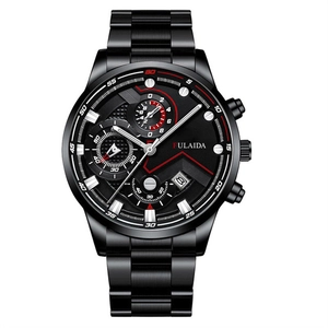 Detail view of all-black steel business watch with chronograph dials and red accents