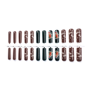 Christmas press-on nails set with brown gingerbread man and Ho Ho Ho patterns
