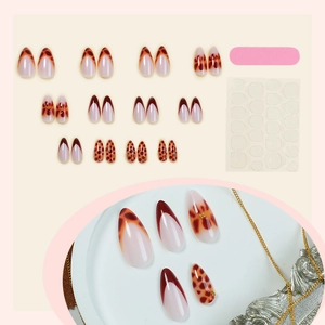 Glossy almond press-on nails with amber leopard print and gold detail set