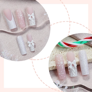 Christmas press-on nails with 3D bow, snowflake prints and pink cable knit pattern