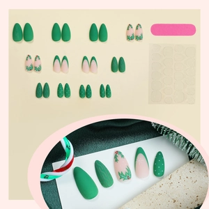 Christmas almond press-on nails with green matte holly leaves and snowflake patterns