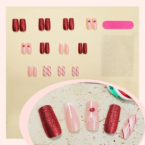 Christmas press-on nails set with red glitter, white tips, and reindeer art designs