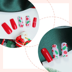 Christmas press-on nails set with red festive patterns like trees and bells in long coffin shape