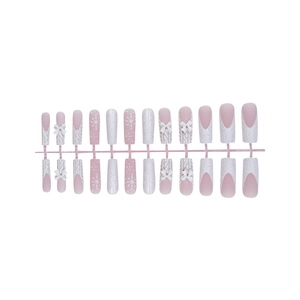 Pink and white Christmas press-on nails featuring snowflakes and 3D sweater knit textures