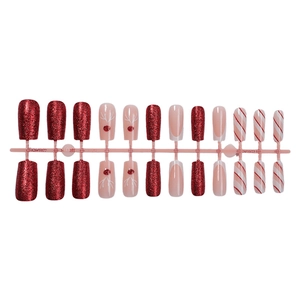 Christmas press-on nails set with red glitter, reindeer silhouettes, and candy stripes