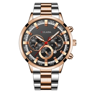 Macro shot of men's rose gold and silver chronograph watch with functional sub-dials
