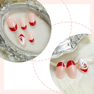 Short oval Christmas press-on nails featuring red French tips and Santa Claus hand-painted art