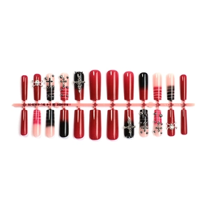 Gothic press-on nail set with black gradient, red accents, and metal cross charms