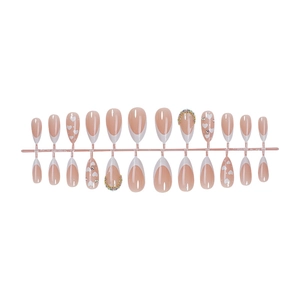 Almond French press-on nails with white heart designs and rhinestones on pink base