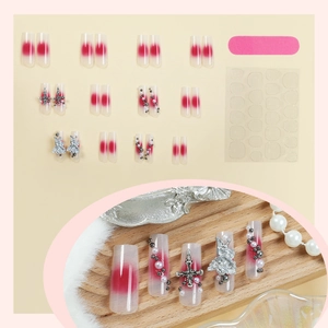 Press-on nail set with blush design, cross charms, pearls, and application tools