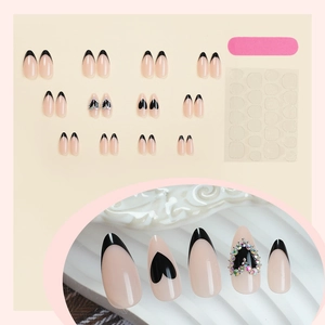 Long almond false nails set with French black tips, heart patterns and colorful rhinestones
