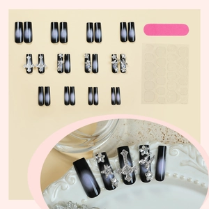 Gothic black and white gradient press-on nails with silver cross and star ornaments