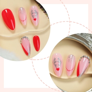 Christmas almond press-on nails with red glitter and silver reindeer horn designs
