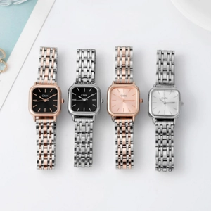 Detail of four luxury square dial women's watches with various metal strap colors