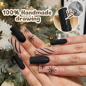Detail of 3D knit texture and snowflake art on black matte press-on nails