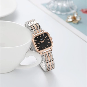 Close-up of luxury square watch with rose gold indices and two-tone metal link strap
