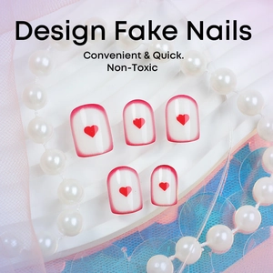 French square press-on nails with red heart patterns and pearl jewelry background