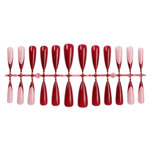 Glossy stiletto press-on nails featuring solid dark red and classic French tip design