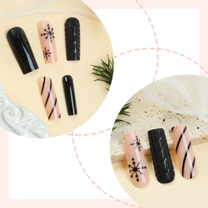 Christmas press-on nails featuring black snowflake patterns and 3D sweater texture designs