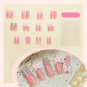 Faux ongles longs rose nude avec nœuds 3D, strass et style French manucure