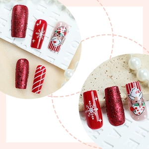 Festive Christmas press-on nails set with red glitter, white snowflakes and Santa designs