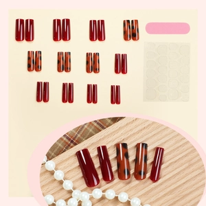 Long trapezoid press-on nails set in caramel leopard print and deep red finish