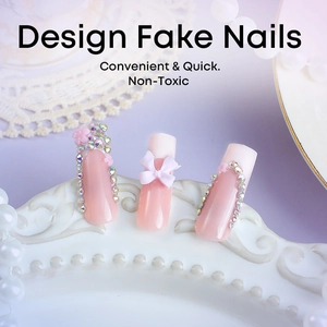 Pink gradient coffin nails with rhinestones and white butterfly bow on a ceramic plate