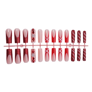 Christmas press-on nails with red glitter, French tips, snowflakes, and candy cane stripes
