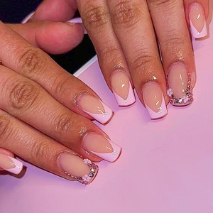 Detailed view of pink French long square nails with 3D flowers and crystal rhinestones