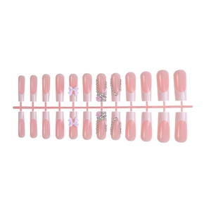 Pink French ombre press-on nails with 3D bows, rhinestones and pearls on long coffin tips