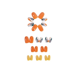 Short round press-on nails set featuring bright orange, yellow, and leaf patterns