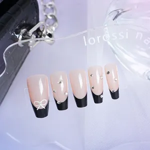 Elegant French black tip press-on nails with white bow and rhinestones on nude base