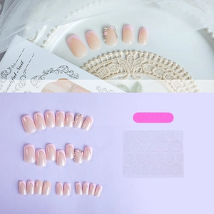 Pink French press-on nails set with 3D floral accents and rhinestones on lace background