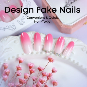 Pink and white gradient oval press-on nails with luxury rhinestone accents on ceramic