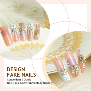 French tip press-on nails with gold cross and heart charms on white feather decor