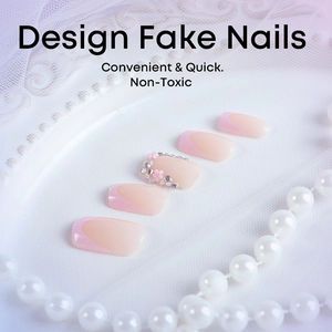 Pink French press-on nails with 3D floral accents and rhinestones on lace display