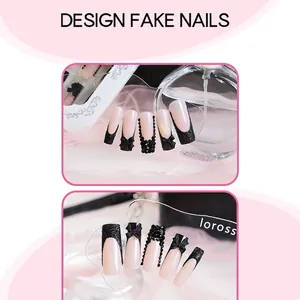 Handmade black French press-on nails with bow accents and sparkling rhinestones